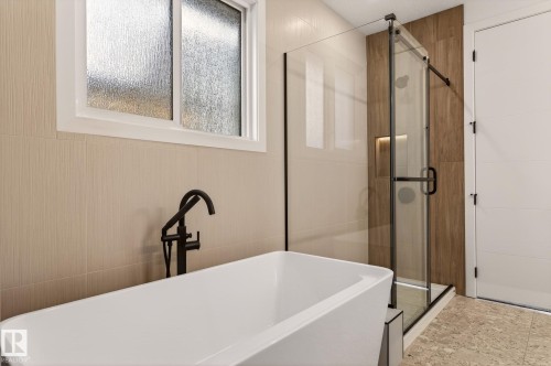 Bathroom featuring a stall shower and a soaking tub - 9 Elwyck Gate, Spruce Grove, AB - Indoor Photo Showing Bathroom