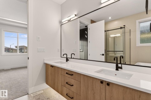 Full bathroom featuring a stall shower, double vanity, and carpet flooring - 9 Elwyck Gate, Spruce Grove, AB - Indoor