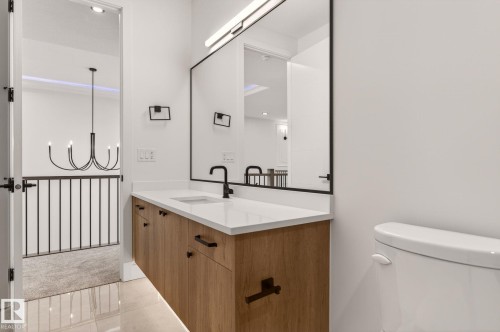 Half bath with vanity, hanging lights, and light tile patterned flooring - 9 Elwyck Gate, Spruce Grove, AB - Indoor Photo Showing Bathroom