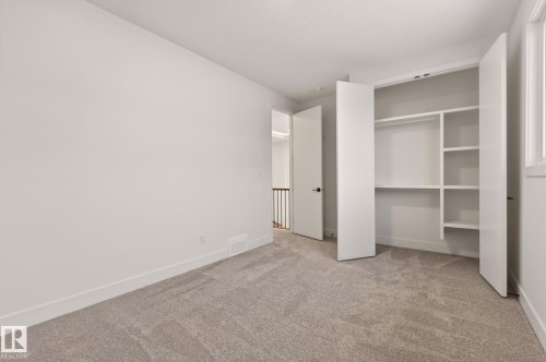 Unfurnished bedroom with light colored carpet and a closet - 9 Elwyck Gate, Spruce Grove, AB - Indoor Photo Showing Other Room