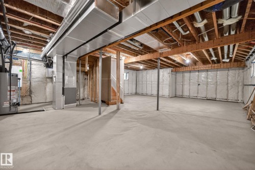 Unfinished below grade area featuring water heater and heating unit - 9 Elwyck Gate, Spruce Grove, AB - Indoor Photo Showing Basement