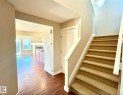 Stairway featuring a textured ceiling, hardwood / wood-style flooring, and a fireplace - 3705 11 Street, Edmonton, AB  - Indoor Photo Showing Other Room 