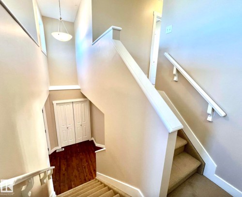 Stairway with a high ceiling and wood finished floors - 3705 11 Street, Edmonton, AB - Indoor Photo Showing Other Room
