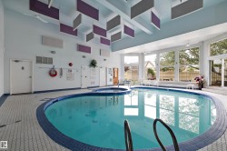 View of pool with a connected hot tub and ceiling fan - 
