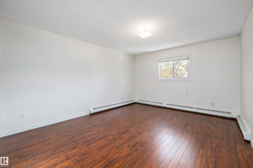 Primary bedroom with extra closet space leading to ensuite - 218 18012 95 Avenue, Edmonton, AB - Indoor Photo Showing Other Room