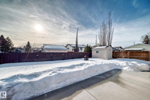 Snowy yard featuring a fenced backyard and a storage shed - 12203 147 Avenue, Edmonton, AB - Outdoor