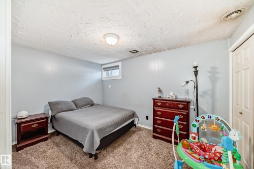 Carpeted bedroom with a closet and a textured ceiling - 12203 147 Avenue, Edmonton, AB - Indoor Photo Showing Bedroom