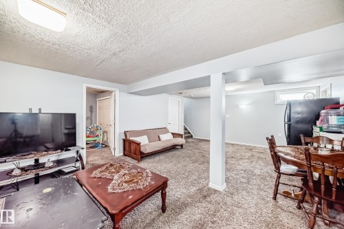 Living area with a textured ceiling and carpet floors - 12203 147 Avenue, Edmonton, AB - Indoor