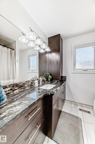 Full bath with vanity, light tile patterned flooring, and a shower with shower curtain - 12203 147 Avenue, Edmonton, AB - Indoor