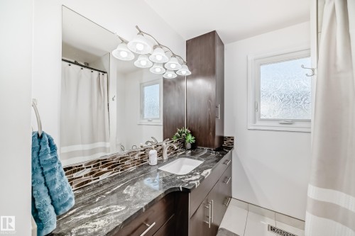Bathroom with vanity, a shower with shower curtain, and light tile patterned floors - 12203 147 Avenue, Edmonton, AB - Indoor Photo Showing Bathroom