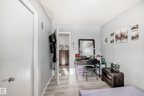 Bedroom with a desk, light wood-style flooring, and a closet - 12203 147 Avenue, Edmonton, AB - Indoor