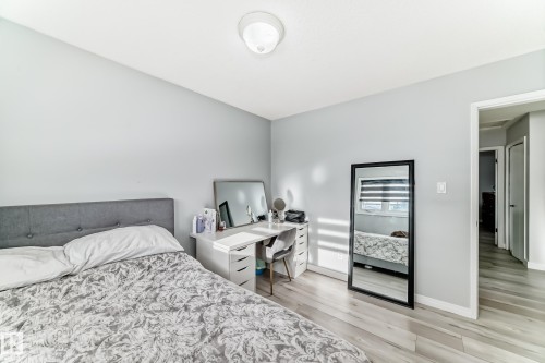 Bedroom with light wood-type flooring and an office area - 12203 147 Avenue, Edmonton, AB - Indoor Photo Showing Bedroom