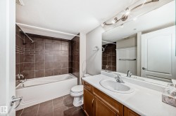 Bathroom featuring vanity, shower / washtub combination, and dark tile patterned floors - 