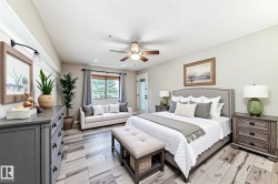 Bedroom featuring a ceiling fan and light wood-type flooring - 