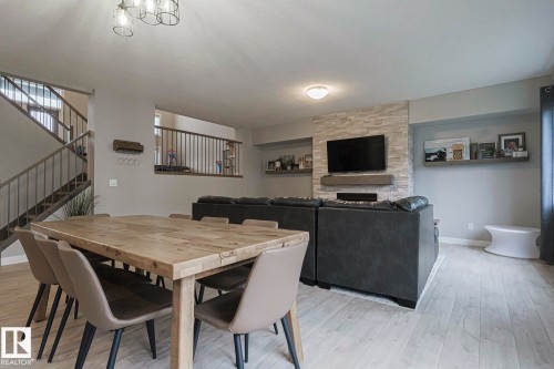 Dining room featuring light wood-style flooring and a fireplace - 2011 201 Street, Edmonton, AB - Indoor Photo Showing Dining Room