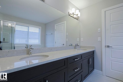 Full bath featuring double vanity and a shower stall - 2011 201 Street, Edmonton, AB - Indoor Photo Showing Bathroom