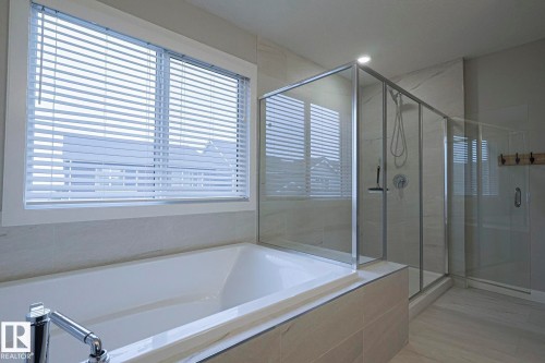 Full bath with a shower stall and a bath - 2011 201 Street, Edmonton, AB - Indoor Photo Showing Bathroom