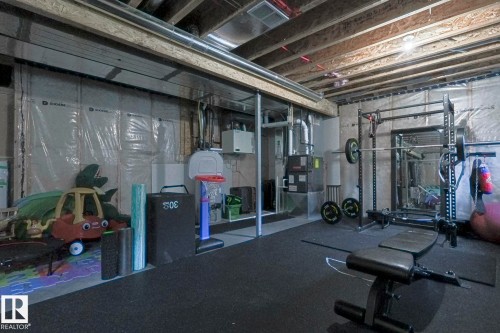 Workout area featuring heating unit and rubber floors - 2011 201 Street, Edmonton, AB - Indoor Photo Showing Basement