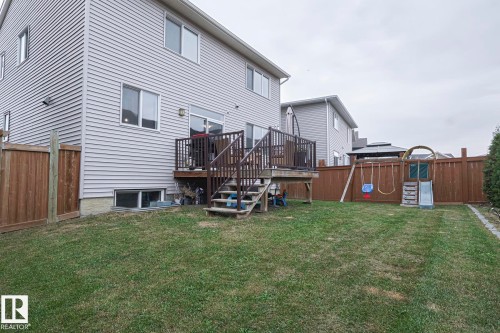 Rear view of property featuring a fenced backyard, a playground, and a deck - 2011 201 Street, Edmonton, AB - Outdoor With Deck Patio Veranda