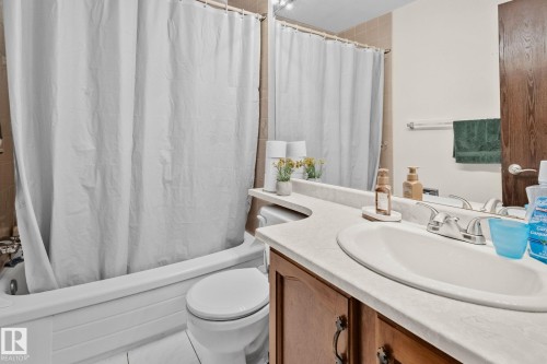 Bathroom featuring vanity and shower / bath combo with shower curtain - 17523 95 Street, Edmonton, AB - Indoor Photo Showing Bathroom