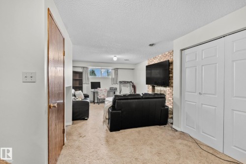 Living area featuring a textured ceiling and light colored carpet - 17523 95 Street, Edmonton, AB - Indoor