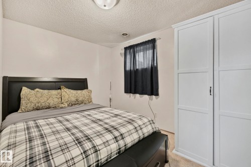Bedroom with a textured ceiling and light colored carpet - 17523 95 Street, Edmonton, AB - Indoor Photo Showing Bedroom