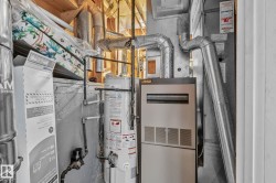 Utility room featuring gas water heater - 