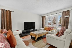 Living area featuring a textured ceiling and wood finished floors - 