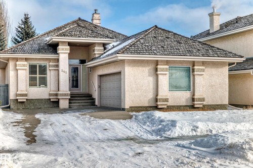 View of front of house with stucco siding and a garage - 241 Darlington Crescent, Edmonton, AB - Outdoor With Facade