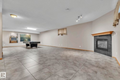 Massive rec room with loads of space for movie nights, games room - 1217 Summerside Drive, Edmonton, AB - Indoor With Fireplace