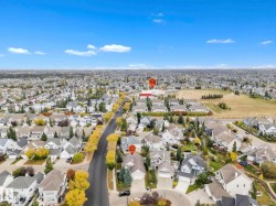 Aerial view of property and surrounding area featuring nearby suburban area - 