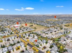 Aerial view of property and surrounding area featuring nearby suburban area - 