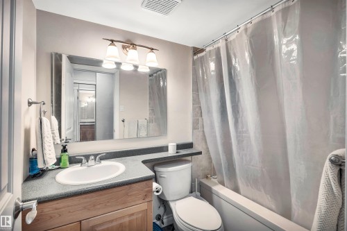 Full bath with vanity and shower / bath combo with shower curtain - 402 9929 113 Street, Edmonton, AB - Indoor Photo Showing Bathroom