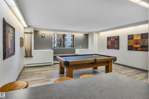 Game room with billiards, light wood-style floors, and baseboard heating - 402 9929 113 Street, Edmonton, AB - Indoor Photo Showing Other Room