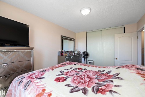 Bedroom with a textured ceiling and a closet - 127 Cornell Court, Edmonton, AB - Indoor Photo Showing Bedroom