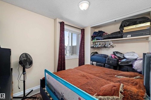 Bedroom with a textured ceiling and baseboards - 127 Cornell Court, Edmonton, AB - Indoor Photo Showing Bedroom