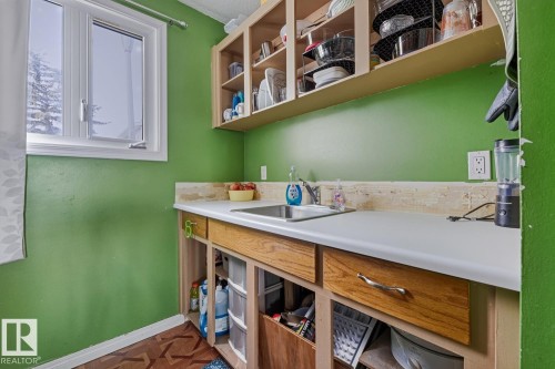Laundry room featuring baseboards and parquet flooring - 18307 66 Avenue, Edmonton, AB - Indoor