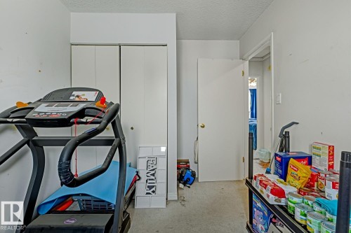 Workout room featuring a textured ceiling and concrete flooring - 18307 66 Avenue, Edmonton, AB - Indoor