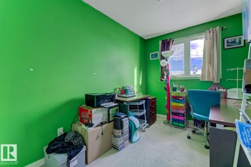 Carpeted office featuring baseboards and a textured ceiling - 18307 66 Avenue, Edmonton, AB - Indoor