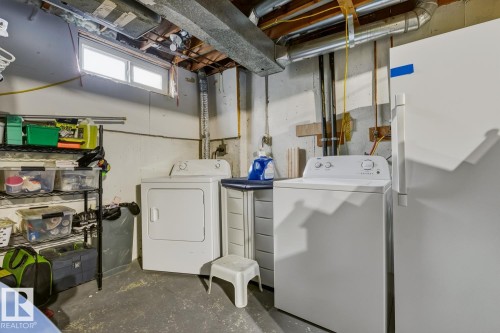 Laundry area featuring unfinished concrete floors and washer and dryer - 18307 66 Avenue, Edmonton, AB - Indoor Photo Showing Laundry Room
