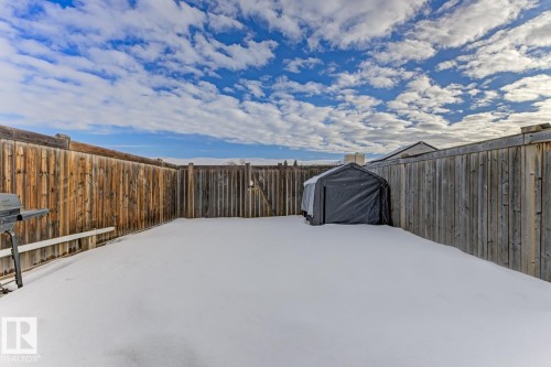 Yard covered in snow featuring a fenced backyard - 18307 66 Avenue, Edmonton, AB - Outdoor