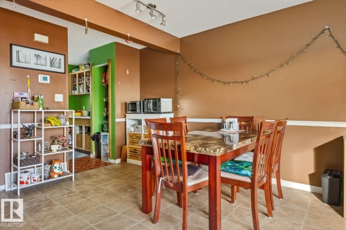 Dining room with baseboards and light tile patterned flooring - 18307 66 Avenue, Edmonton, AB - Indoor Photo Showing Dining Room