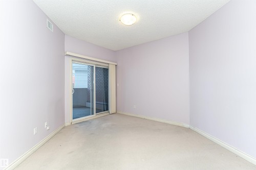Carpeted spare room featuring baseboards and a textured ceiling - 112 260 Sturgeon Road, St. Albert, AB - Indoor Photo Showing Other Room