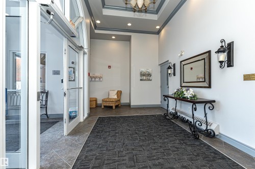 Foyer featuring recessed lighting, a high ceiling, ornamental molding, and baseboard heating - 112 260 Sturgeon Road, St. Albert, AB - Indoor Photo Showing Other Room