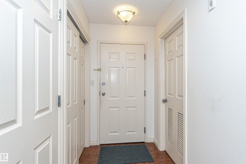 Doorway to outside featuring a textured ceiling and wood finished floors - 112 260 Sturgeon Road, St. Albert, AB - Indoor Photo Showing Other Room