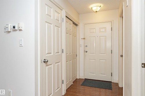 Doorway with wood finished floors and a textured ceiling - 112 260 Sturgeon Road, St. Albert, AB - Indoor Photo Showing Other Room