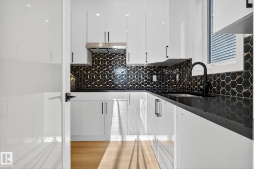 Kitchen with white cabinets, dark stone countertops, and modern cabinets - 3508 6 Street, Edmonton, AB - Indoor Photo Showing Kitchen With Upgraded Kitchen