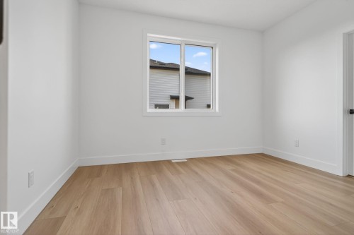 Spare room featuring baseboards and light wood-style flooring - 3508 6 Street, Edmonton, AB - Indoor Photo Showing Other Room