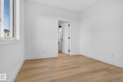 Spare room with light wood-type flooring and baseboards - 3508 6 Street, Edmonton, AB - Indoor Photo Showing Other Room