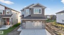 Craftsman-style home featuring stone siding, a shingled roof, a residential view, concrete driveway, and a garage - 3508 6 Street, Edmonton, AB  - Outdoor 
